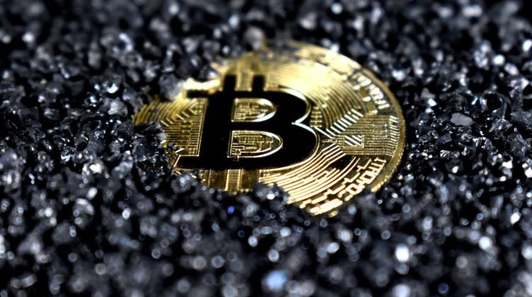 Bitcoin in black sand