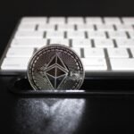 An Ethereum (Layer 2) coin in front of a keyboard