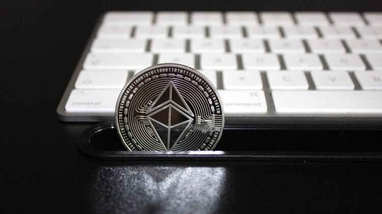 An Ethereum (Layer 2) coin in front of a keyboard