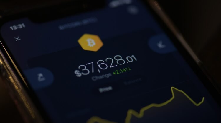 A phone with a crypto chart on the screen