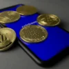 Various crypto coins on top of a smartphone