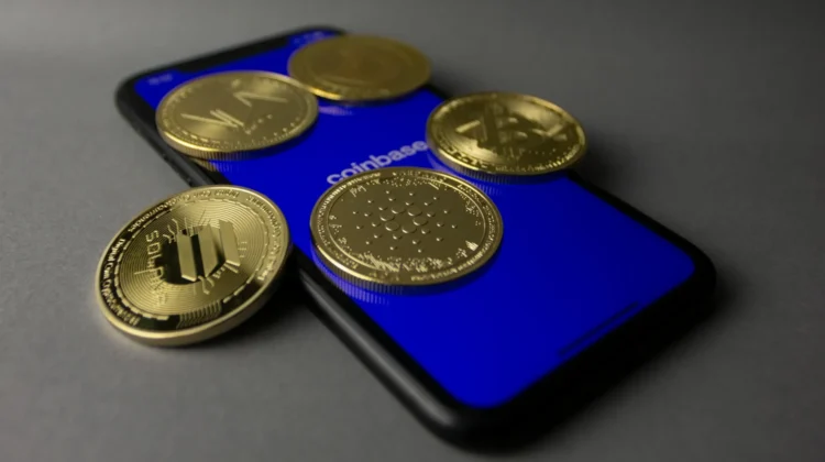 Various crypto coins on top of a smartphone