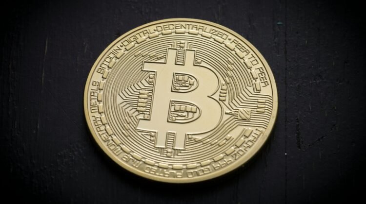A single bitcoin on a black background